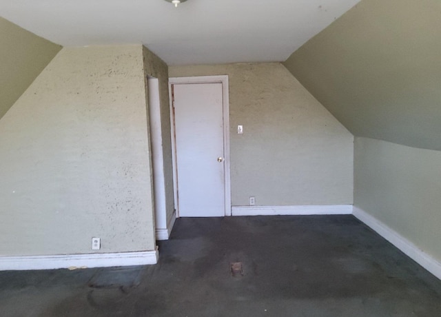 additional living space featuring vaulted ceiling