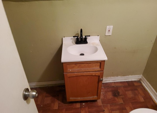 bathroom with vanity and parquet flooring