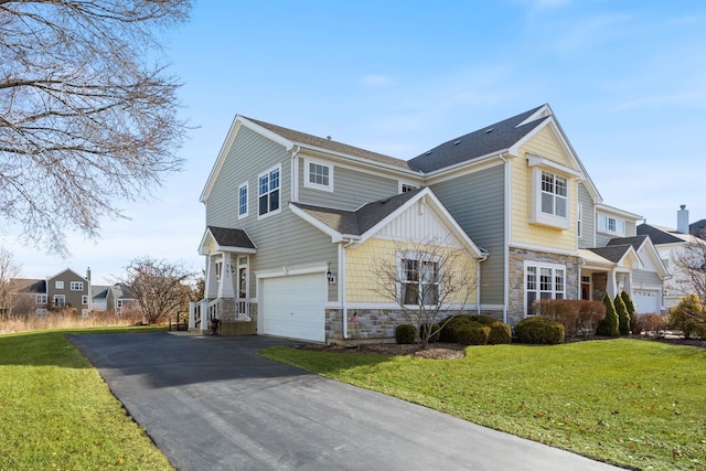 view of front of property featuring a garage and a front lawn