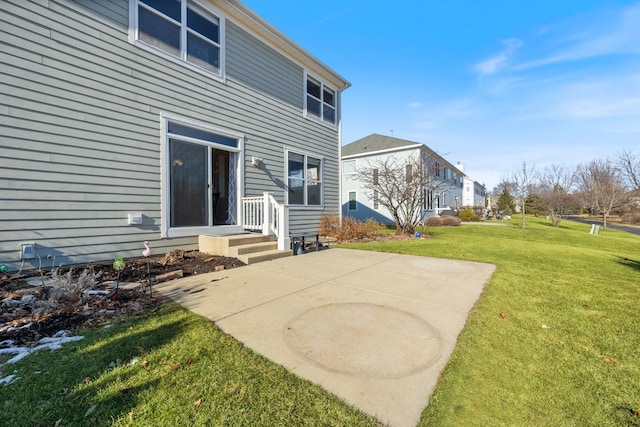 back of house featuring a yard and a patio area