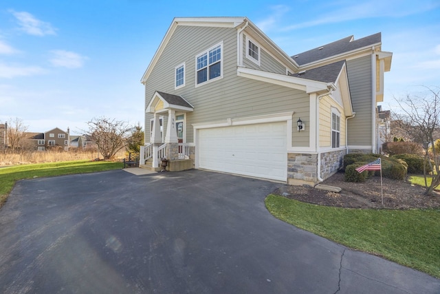 view of front of property featuring a garage and a front yard