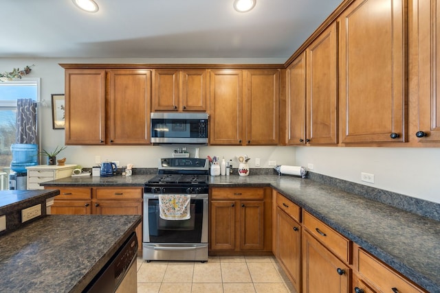 kitchen with stainless steel appliances and light tile patterned floors