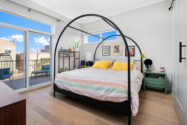 bedroom featuring ornamental molding, access to outside, and light hardwood / wood-style flooring