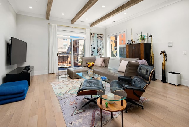 living room with beamed ceiling, light hardwood / wood-style flooring, and ornamental molding