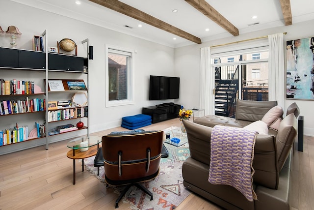 living room featuring beam ceiling and light hardwood / wood-style floors