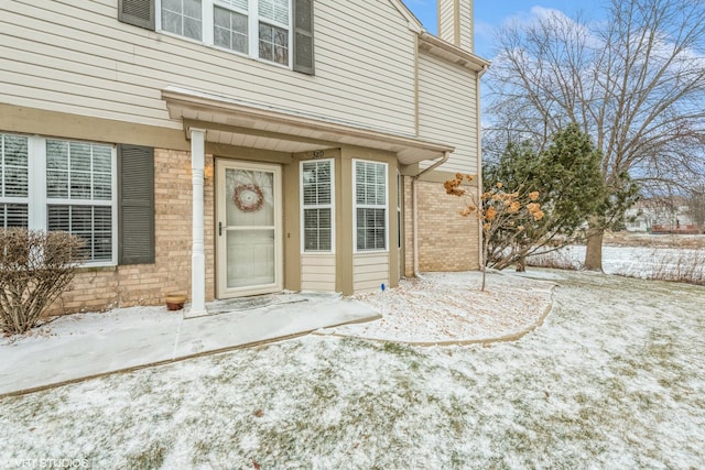 view of snow covered property entrance