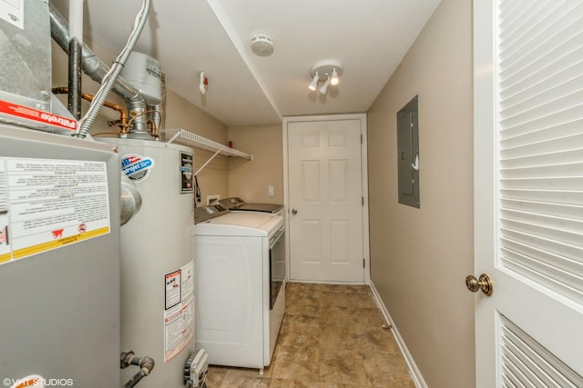 clothes washing area with separate washer and dryer, electric panel, and gas water heater