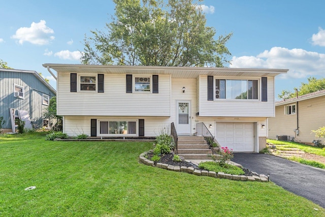 raised ranch with a front yard and a garage