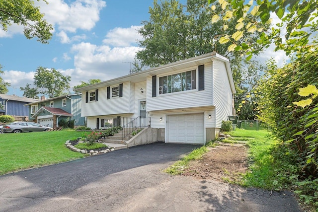 raised ranch with a front yard and a garage