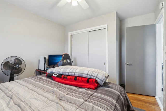 bedroom with ceiling fan, hardwood / wood-style flooring, and a closet