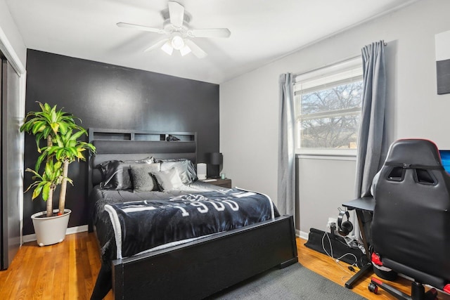 bedroom with hardwood / wood-style floors and ceiling fan