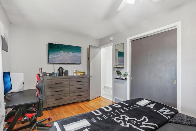 bedroom with a closet, ceiling fan, and light hardwood / wood-style floors