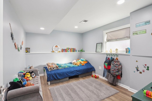 bedroom with hardwood / wood-style floors