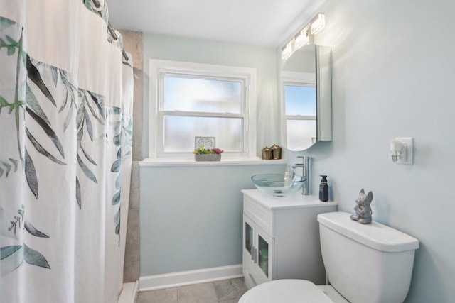 bathroom with vanity, toilet, tile patterned flooring, and a shower with curtain