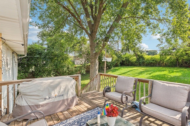 deck featuring a yard and grilling area