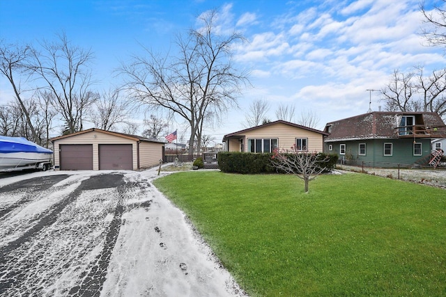 view of home's exterior with a lawn, a garage, and an outbuilding