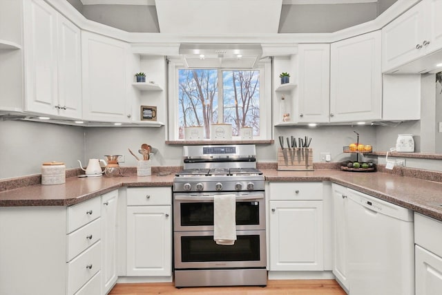 kitchen with white dishwasher, range with two ovens, and white cabinetry