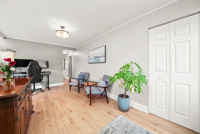 office space with light wood-type flooring and ornamental molding