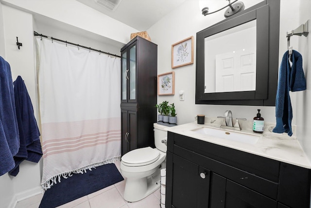 bathroom featuring tile patterned flooring, vanity, and toilet