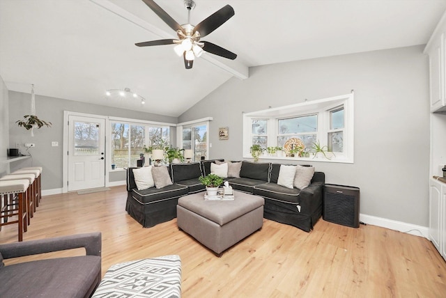 living room with vaulted ceiling with beams, light hardwood / wood-style floors, and ceiling fan