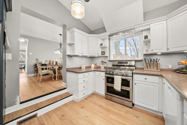 kitchen featuring white cabinets, dishwasher, range with two ovens, and hanging light fixtures