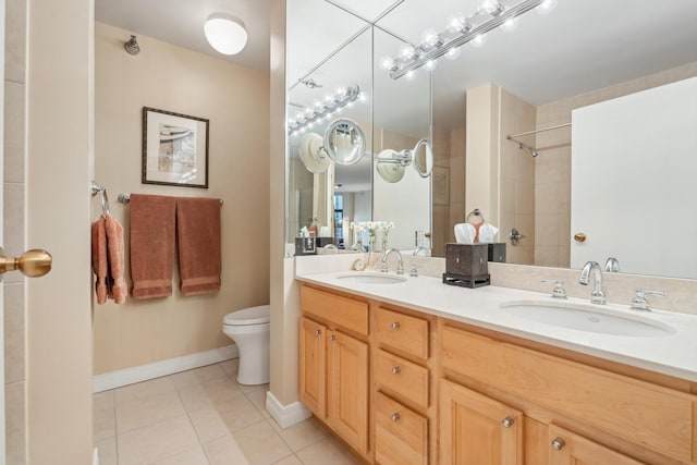 bathroom featuring toilet, a tile shower, tile patterned floors, and vanity