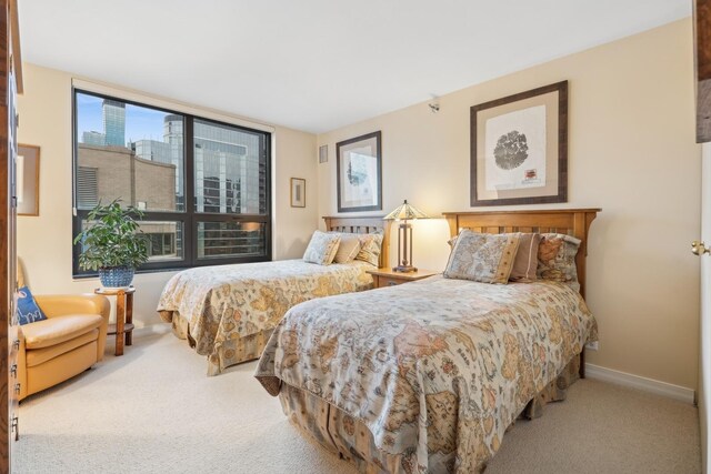 bedroom featuring light carpet