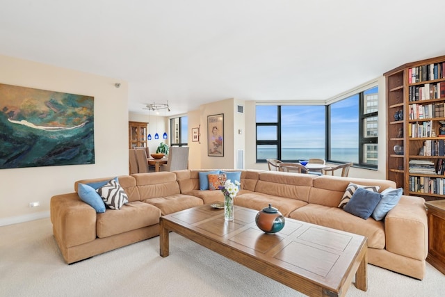 carpeted living room with a water view