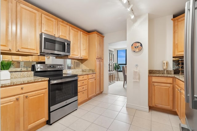 kitchen featuring light stone counters, light tile patterned floors, light brown cabinets, and appliances with stainless steel finishes