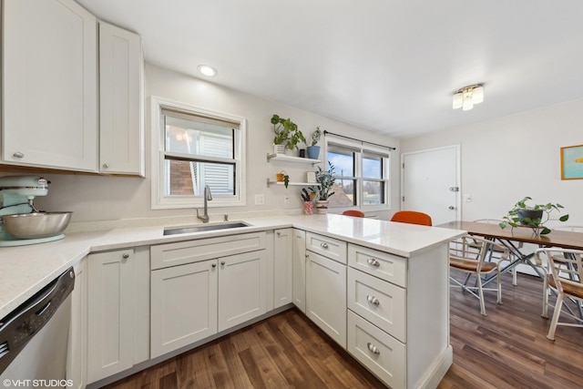 kitchen featuring dishwasher, white cabinetry, dark wood-type flooring, and sink