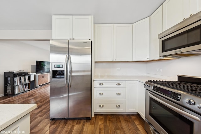 kitchen featuring white cabinets, dark hardwood / wood-style flooring, stainless steel appliances, and light stone counters