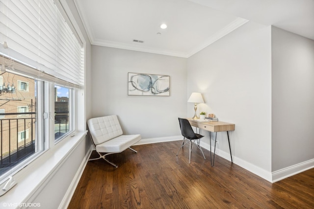 sitting room with ornamental molding and dark wood-type flooring