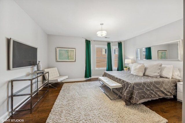 bedroom with dark hardwood / wood-style flooring