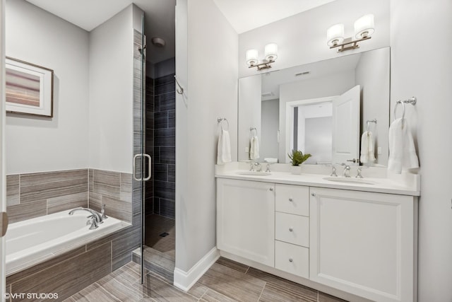 bathroom featuring plus walk in shower and vanity