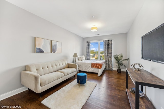 bedroom with dark hardwood / wood-style flooring