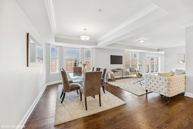 dining space featuring a raised ceiling, dark hardwood / wood-style floors, and ornamental molding