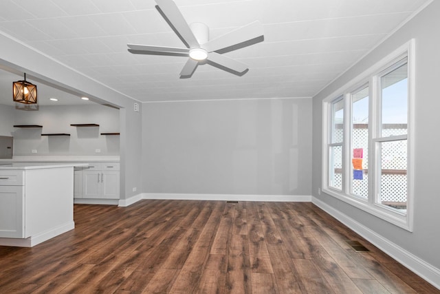 unfurnished living room featuring ceiling fan and dark wood-type flooring