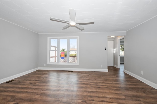 unfurnished room with ceiling fan, ornamental molding, and dark wood-type flooring