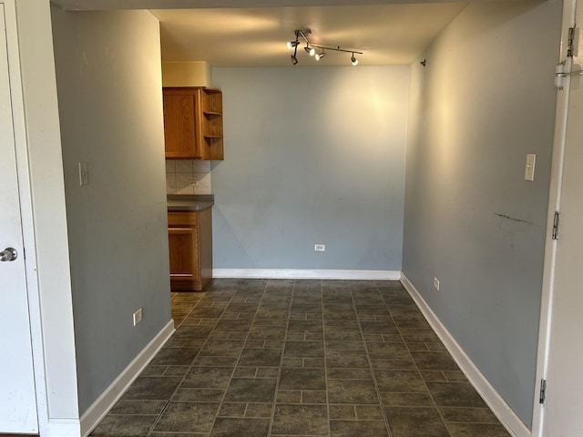 spare room featuring track lighting