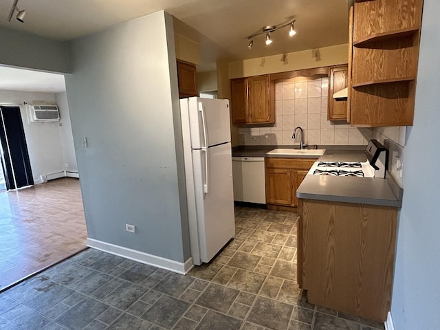 kitchen with a wall mounted air conditioner, white appliances, sink, decorative backsplash, and baseboard heating