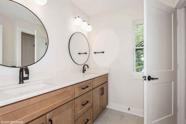 bathroom featuring tile patterned flooring and vanity