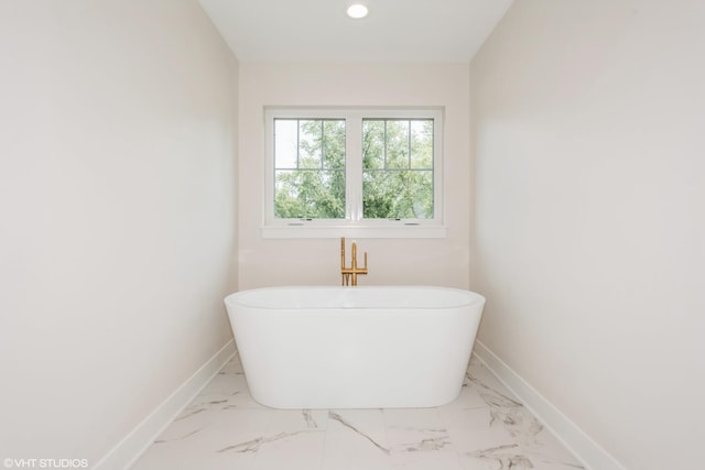 bathroom with a tub to relax in