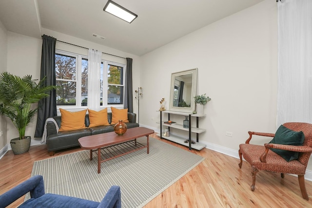 living room featuring light hardwood / wood-style flooring and vaulted ceiling