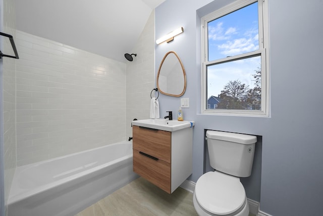 full bathroom featuring hardwood / wood-style flooring, vanity, toilet, and tiled shower / bath combo