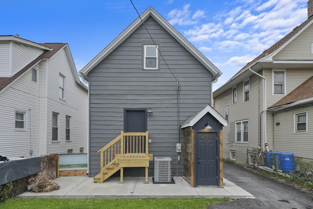 rear view of house featuring central AC