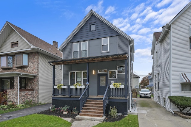 view of property featuring covered porch