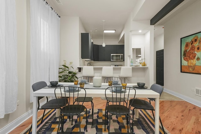 dining area with light wood-type flooring