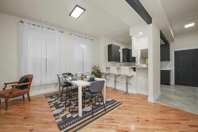 dining space with light hardwood / wood-style floors