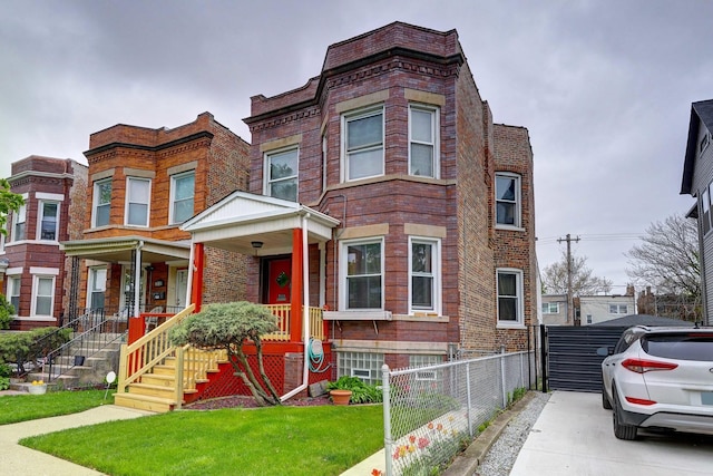 view of front of property with covered porch and a front yard