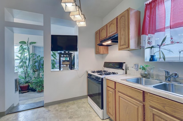 kitchen featuring sink and white range with gas stovetop